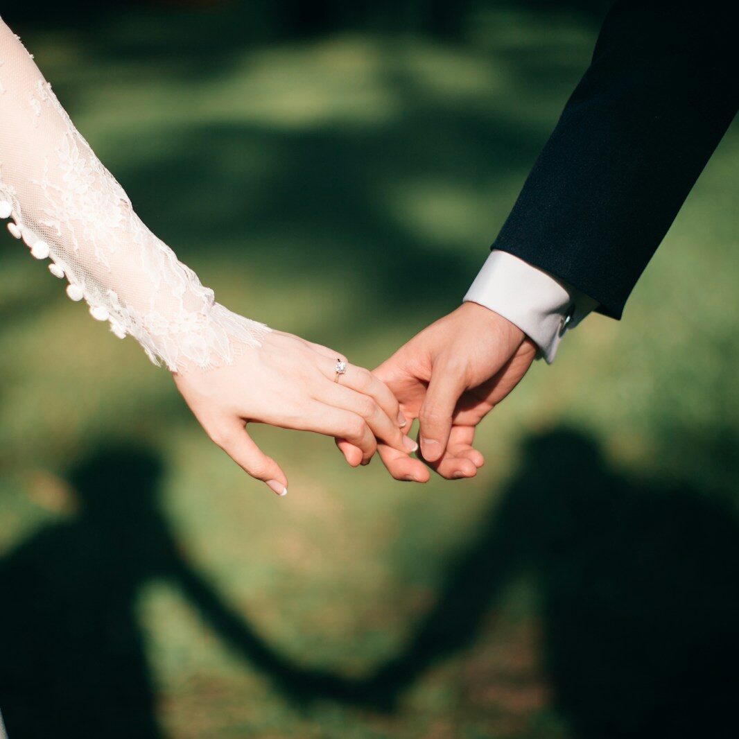 man and woman holding hands focus photo